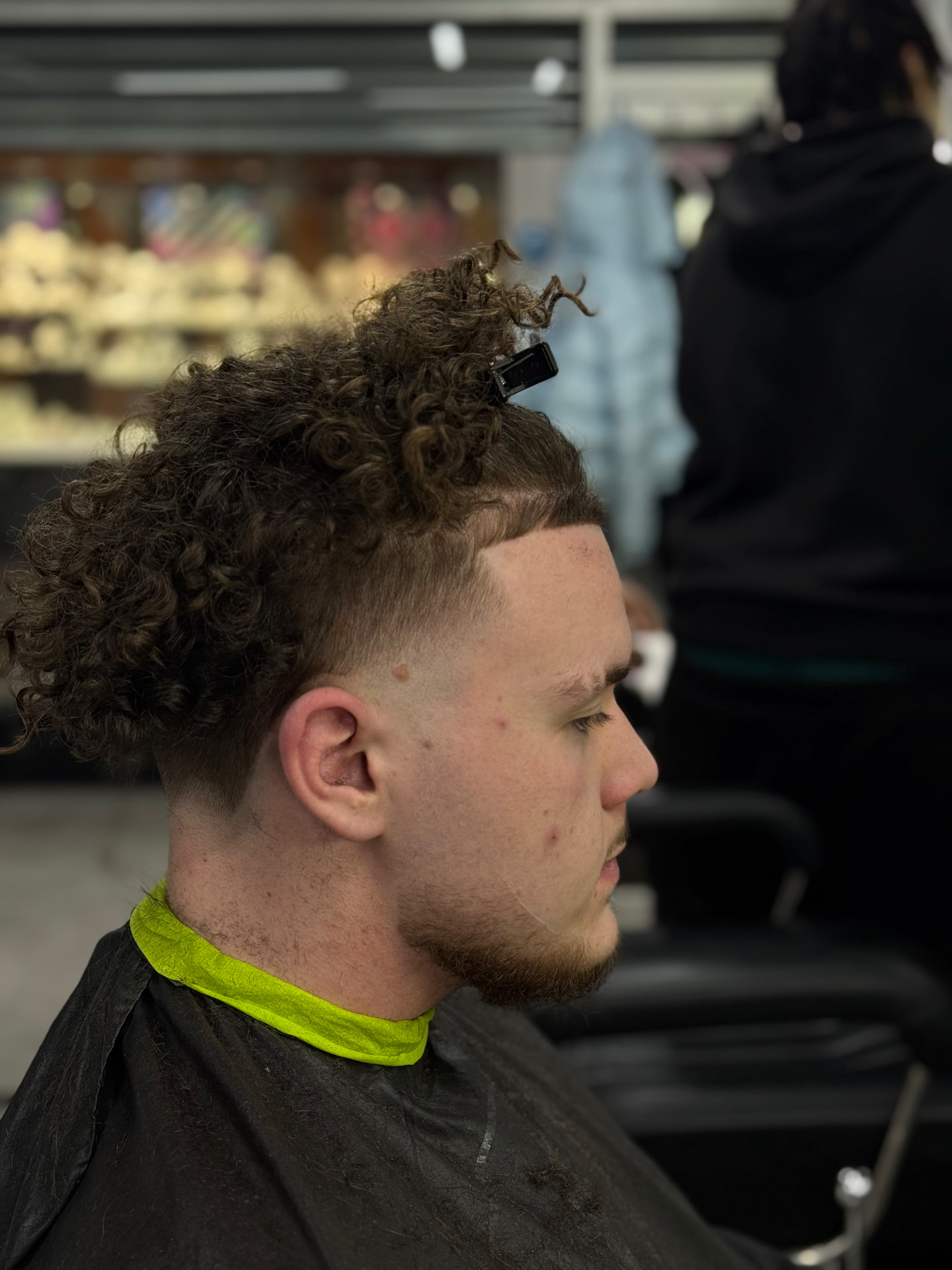 Curly mullet with high skin fade and sharp line-up